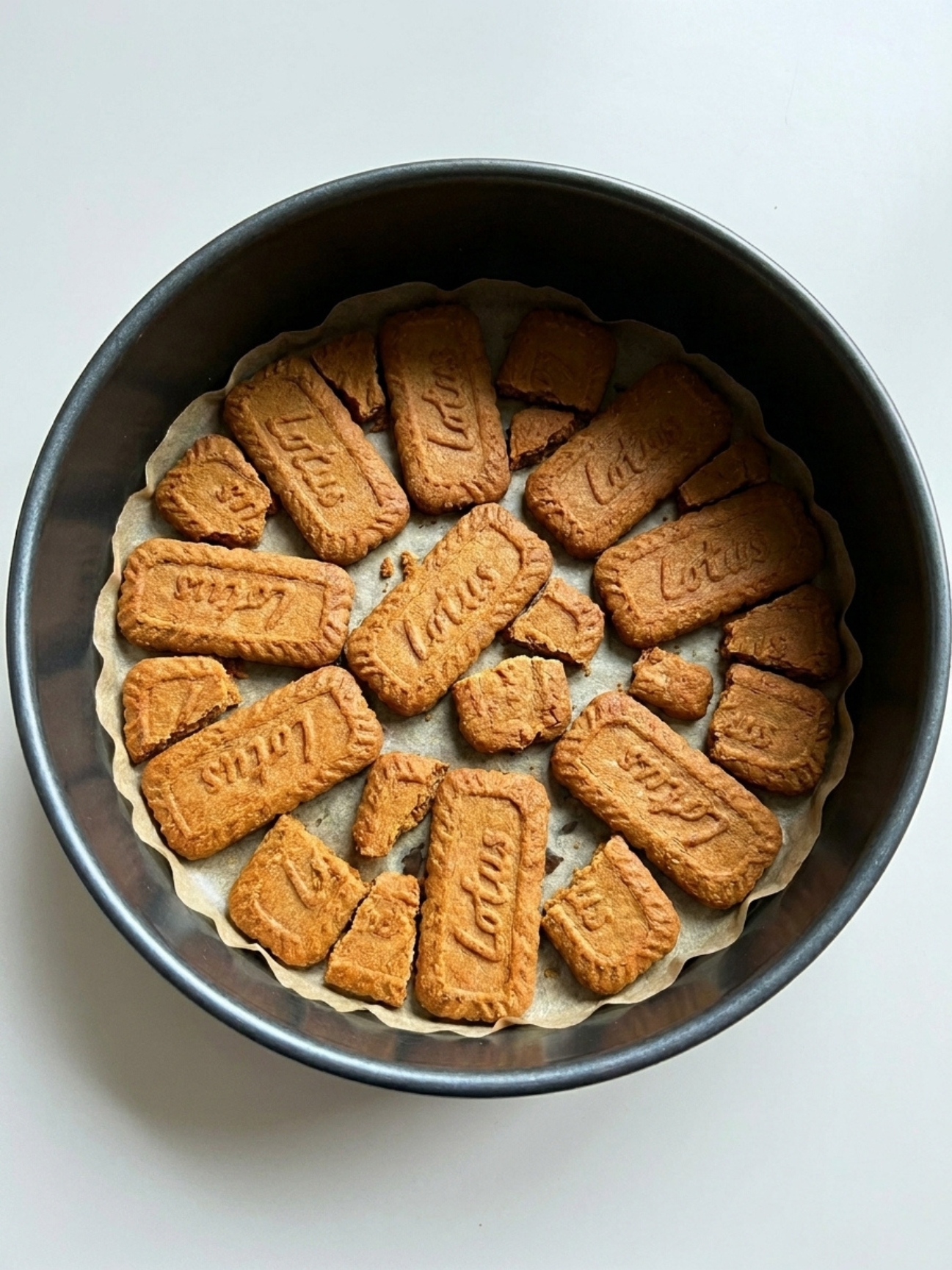 Montage des couches de biscuit speculoos gateau et crème mascarpone dans un moule.